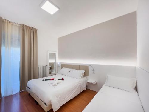 a hotel room with two beds and a window at Hotel Gran Sasso & SPA in Teramo