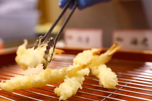 a fork picking up a piece of food on a grill at Oyado Tsukiyo no Usagi in Izumo