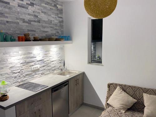 a kitchen with a sink and a counter top at Marmaraki Village House & Apartments in Kardamaina