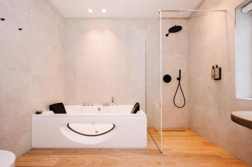 a bathroom with a white sink and a shower at Boutique hotel Margretha in Zandvoort