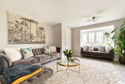 a living room with two couches and a table at Virginia Water Family Getaway in Virginia Water