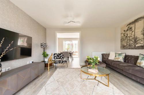 a living room with a couch and a table at Virginia Water Family Getaway in Virginia Water