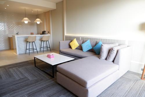 a living room with a couch and a table at Laguna Grand Hotel & Spa Songkhla in Songkhla