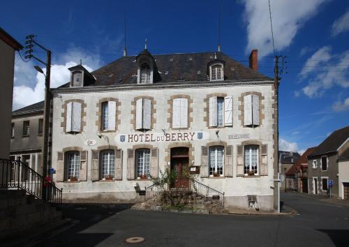 an old white building with a sign on it at Hôtel du Berry in Aigurande