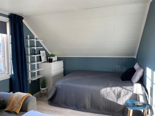 a bedroom with a bed and a book shelf at Modern, small appartment in Larvik