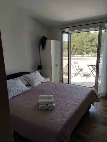 a bedroom with a bed with two towels on it at Apartment Blašković in Novigrad Dalmatia