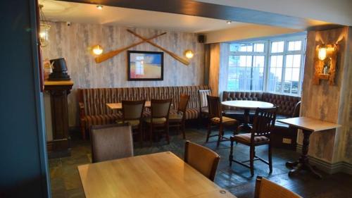 a dining room with tables and chairs in a restaurant at The Two Lifeboats in Sheringham
