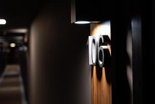 a wooden door with the number on it at Continental Hotel in Lovere