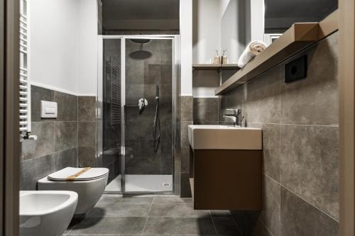 a bathroom with a toilet and a sink and a shower at Continental Hotel in Lovere