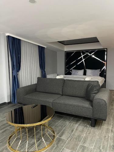 a living room with a couch and a bed at Kent Suit Otel in Istanbul