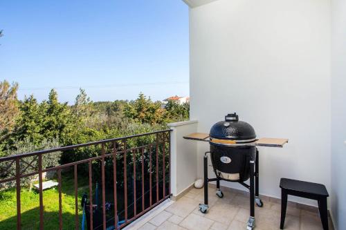a grill on a balcony with a view at Villa Kora in Kallithea Rhodes