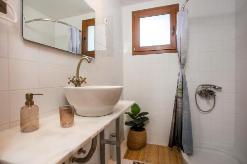 a white bathroom with a sink and a tub at Villa Kora in Kallithea Rhodes