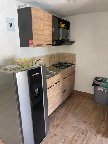 a kitchen with a sink and a stove top oven at Palmar de Jericó Suites in Jericó