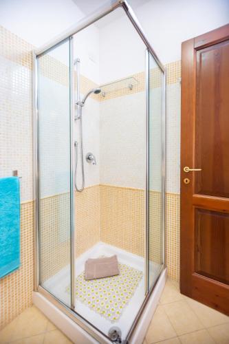 a shower with a glass enclosure in a bathroom at Orange Villasimius House in Villasimius