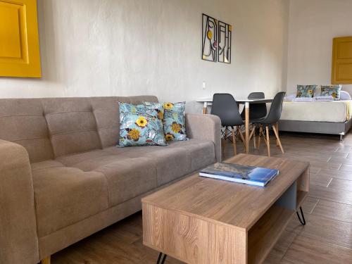 a living room with a couch and a table at Palmar de Jericó Suites in Jericó