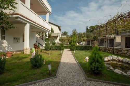 un jardín frente a una casa en Apartman Ana en Rab