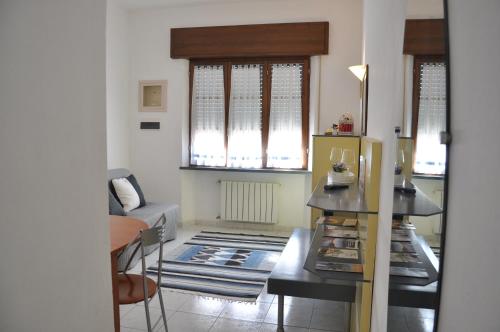 a living room with a refrigerator and a table at Casa Luna - Airport in Pisa