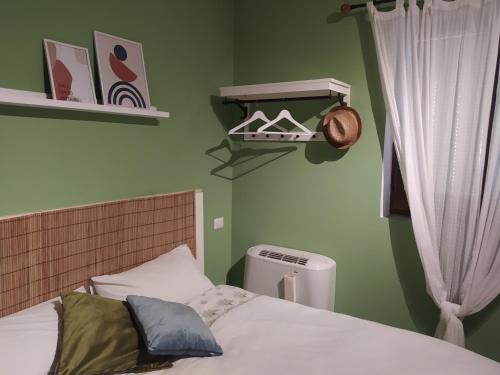 a bed in a room with green walls at B&B Rifugio Della Luna in Satriano di Lucania
