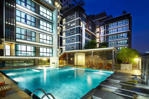 a large swimming pool in the middle of a building at The Plimplace Hotel in Bang Su
