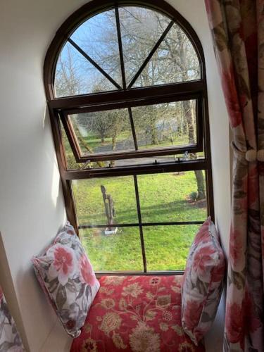 a room with a window with a couch and a chair at Cut Limestone Apartment Riverside Lodge in Carlow
