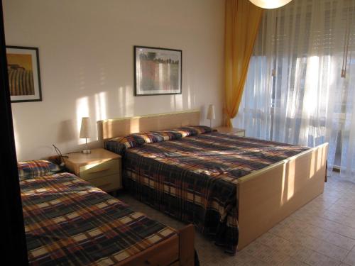 a hotel room with two beds and a window at Appartamento Ritz in Grado