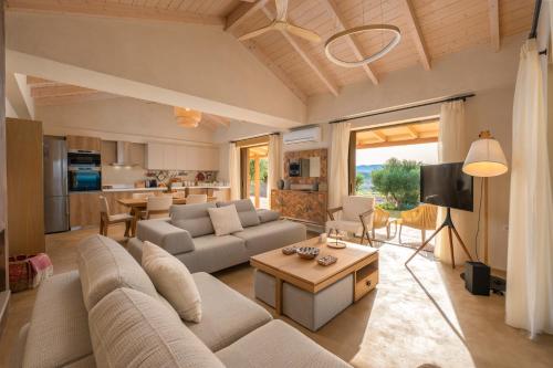 a living room with a couch and a table at Villa Carvella - A Sublimely Relaxing Escape! in Tsilivi