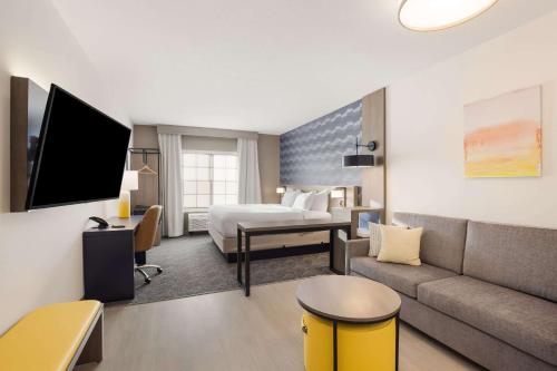 a hotel room with a bed and a couch at Comfort Inn & Suites Gaylord in Gaylord