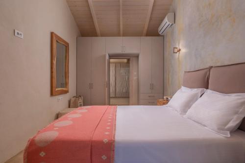 a bedroom with a large bed with a red and white blanket at Villa Carvella - A Sublimely Relaxing Escape! in Tsilivi