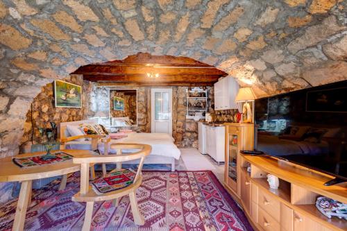 a bedroom with a bed and a kitchen in a room at Holiday Home Pavle in Rijeka Crnojevića