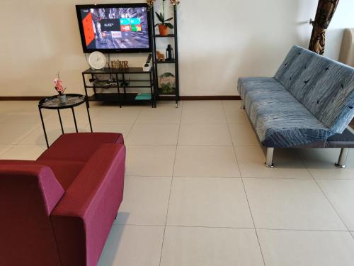a living room with two couches and a tv at Landmark Million Dollar King Suite #Netflix#500mbps WiFi in Tanjong Tokong