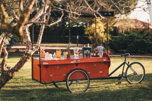a food cart on a bike in the grass at Vale Pisco in Bombarral