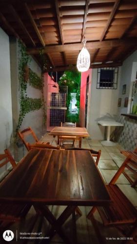 a dining room with a wooden table and chairs at Blue Hostel in Natal