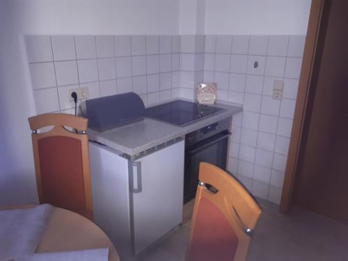 a small kitchen with a counter and a sink at Ferienwohnung Am Floßgraben in Bad Schlema