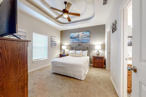 a bedroom with a bed and a ceiling fan at Sea Glass Condominiums #9 in South Padre Island