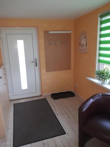 a living room with a sliding door and a couch at Ferienwohnung Am Floßgraben in Bad Schlema