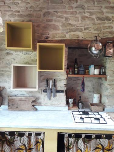 a kitchen with yellow cabinets and a counter top at Casa della Casa in San Severino Marche