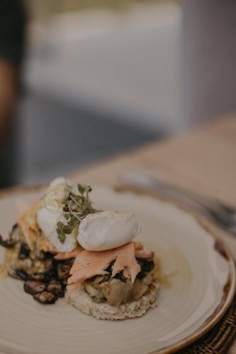 a white plate with food on a table at Qambathi Mountain Lodge in Kamberg Valley