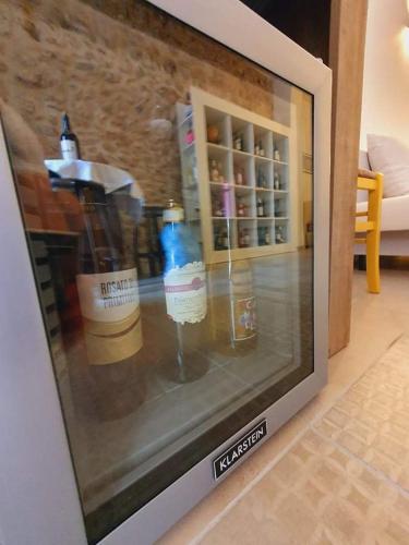 a television screen with bottles in a room at Wine Suite in Torricella