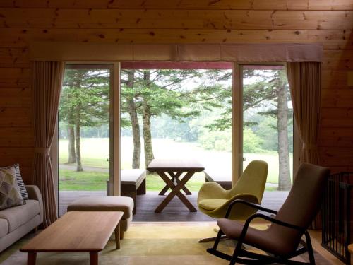 a living room with a couch and chairs and a table at The Prince Villa Karuizawa in Karuizawa
