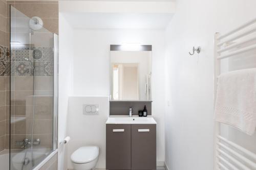 une salle de bain avec un lavabo, des toilettes et une douche dans l'établissement Vill'Arborea - Magnifique T3 au coeur du 7ème, à Lyon
