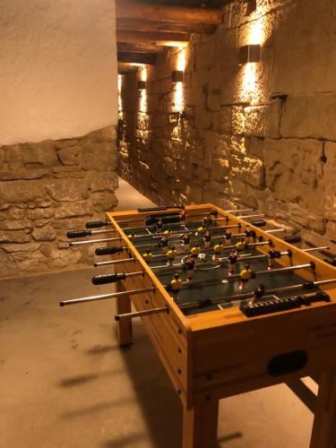 a game room with a foosball table in a stone wall at Solano de Moran in Murillo de Gállego