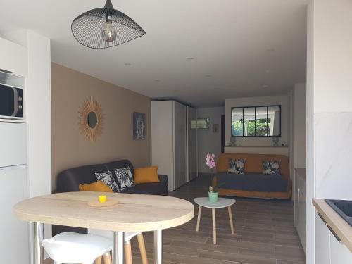 un salon avec une table et un canapé dans l'établissement Studio Le Pénéqué des Anges, à La Ciotat