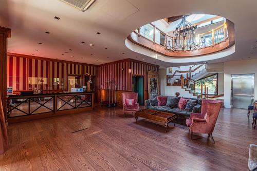 a large living room with a couch and chairs at Nymfasia Resort in Vytina