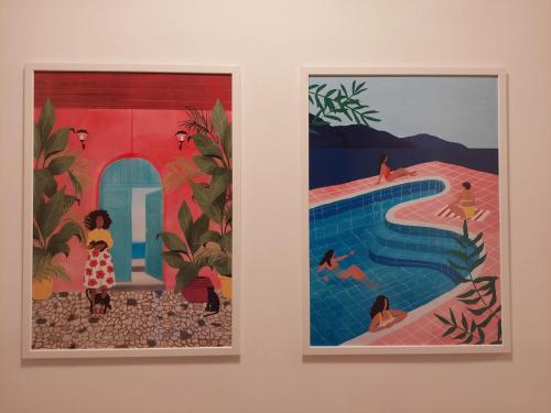 two framed paintings of people in a swimming pool at Vila Luka in Hvar