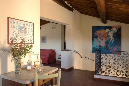 a living room with a table and a couch at La Fattoria del Rio di Sopra - Agriturismo Baldeschi in Tuoro sul Trasimeno