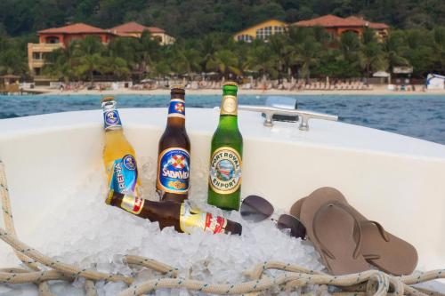 three bottles of beer in the side of a boat at Infinity Bay Spa & Beach Resort in West Bay