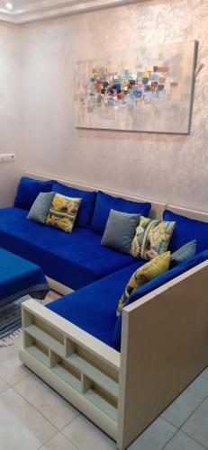 a blue couch with pillows on it in a room at Appartement résidence Atlantic 1 in Kenitra