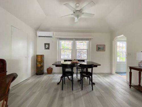 a living room with a dining room table and chairs at Bermuda At the Beach One-Bedroom in Paget Parish