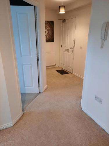 an empty hallway with an open door in a room at Pond View Upper in Airdrie