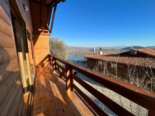 a balcony of a house with a view of a river at Wooden House in Shkodër
